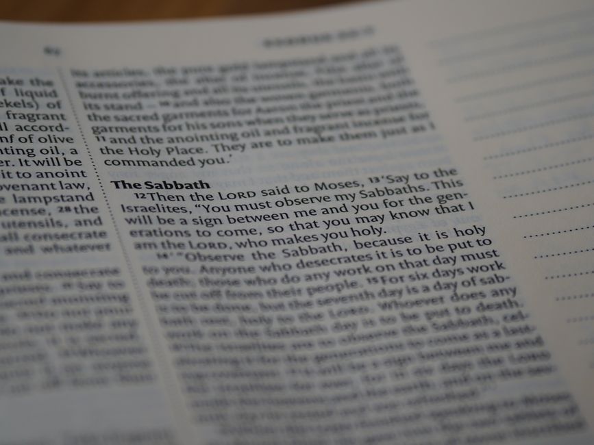 Bible open to Exodus chapter 12 for verse-by-verse commentary and study
