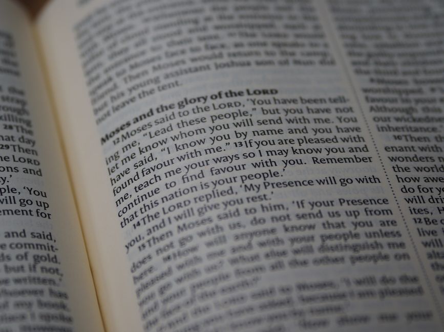 Bible open to Exodus chapter 12 for verse-by-verse commentary and study