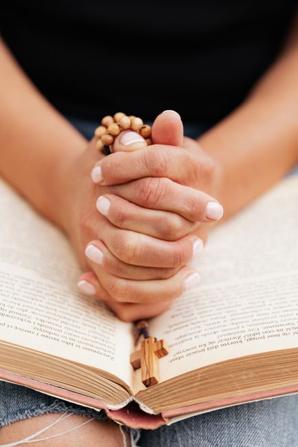 Bible open to Genesis chapter 4 for verse-by-verse commentary and study