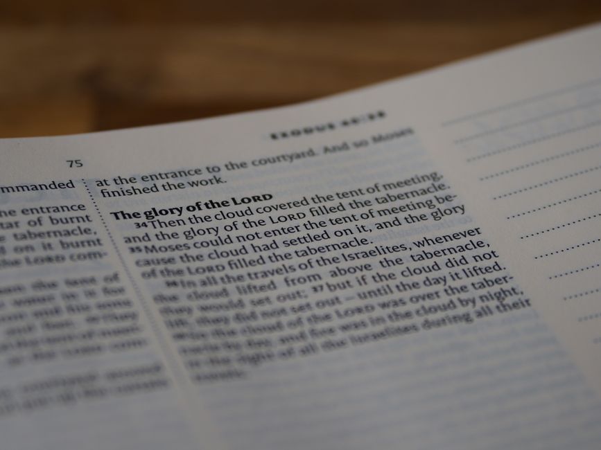 Bible open to Exodus chapter 14 for verse-by-verse commentary and study