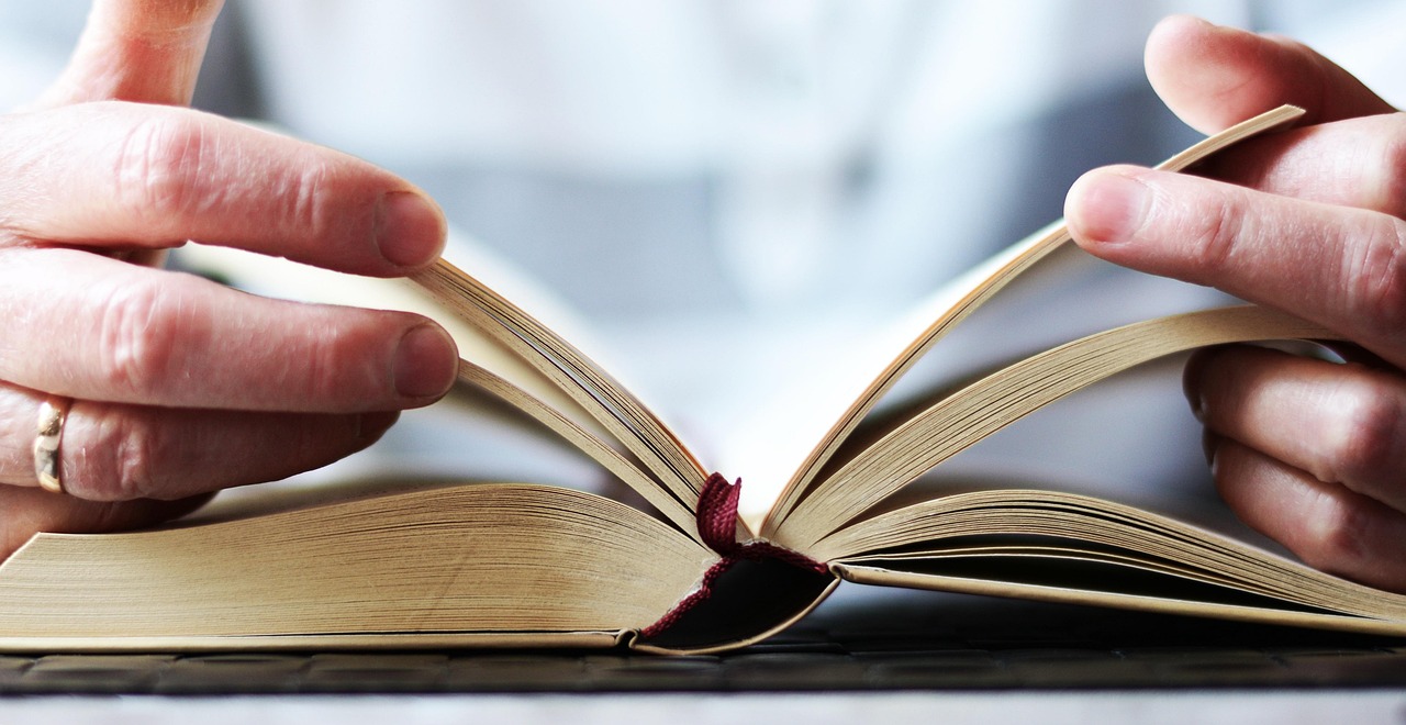 Bible open to Mark chapter 16 for verse-by-verse commentary and study