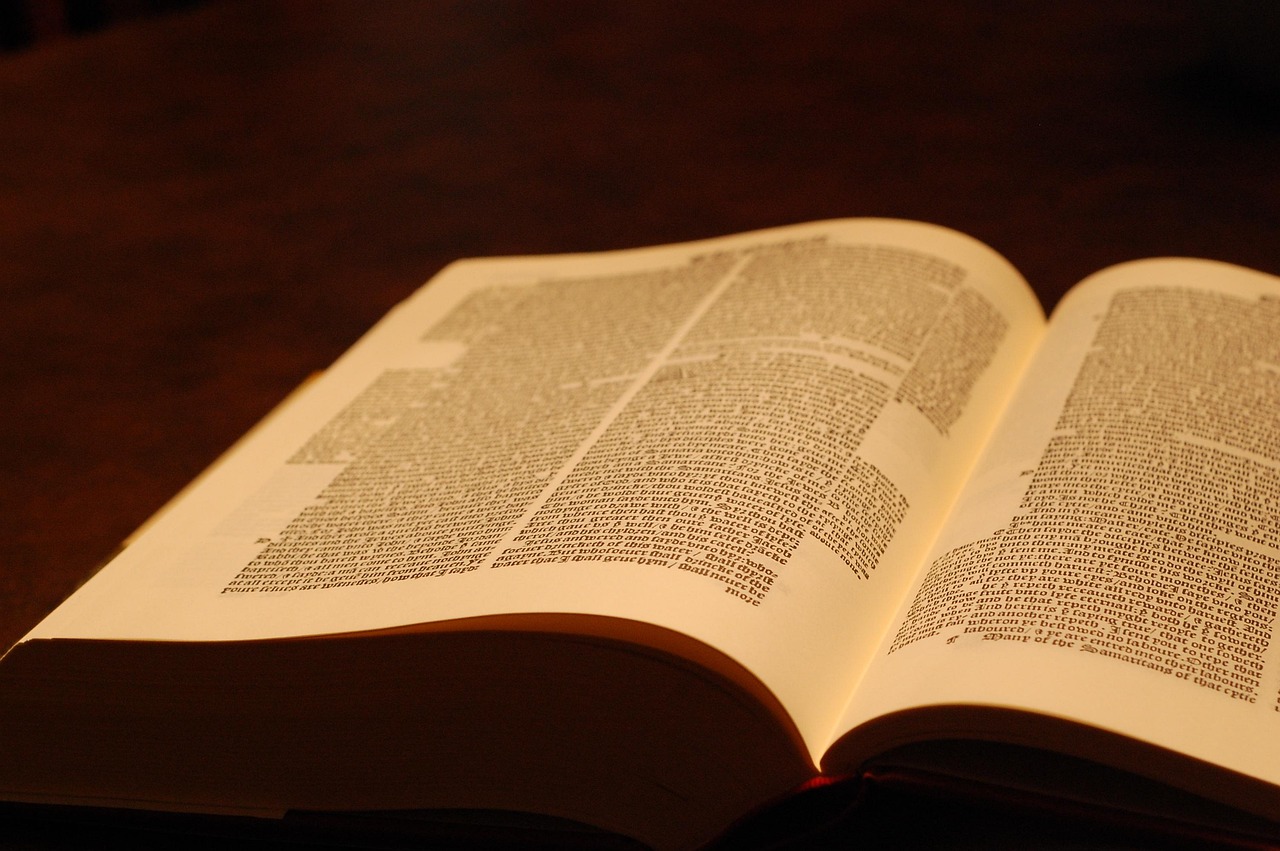 Bible open to Romans chapter 3 for verse-by-verse commentary and study