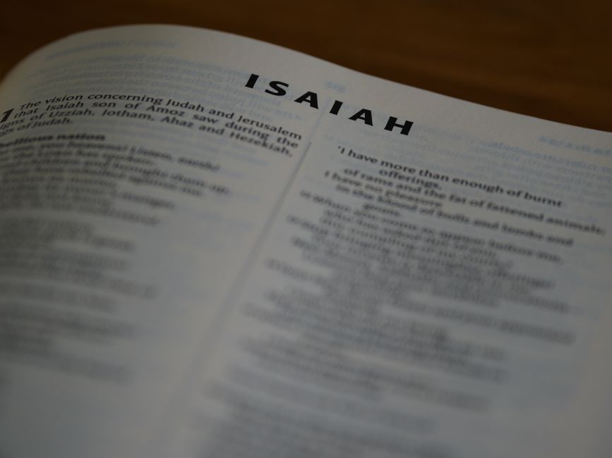 Bible open to Isaiah chapter 61 for verse-by-verse commentary and study