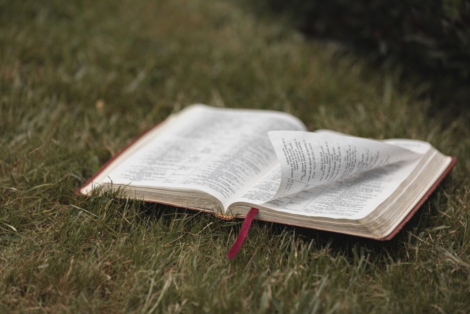 Bible open to Revelation chapter 12 for verse-by-verse commentary and study