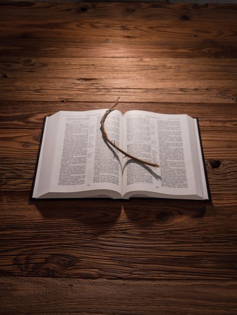 Bible open to 1 John chapter 2 for verse-by-verse commentary and study