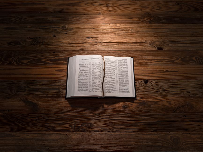 Bible open to Proverbs chapter 28 for verse-by-verse commentary and study
