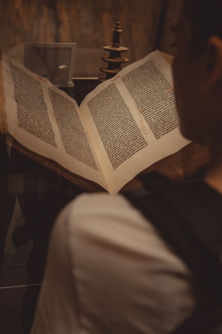 Bible open to Romans chapter 7 for verse-by-verse commentary and study