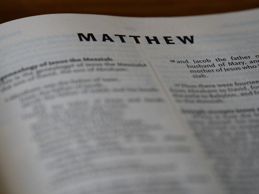 Bible open to Matthew chapter 18 for verse-by-verse commentary and study