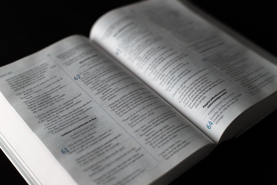 Bible open to Isaiah chapter 54 for verse-by-verse commentary and study