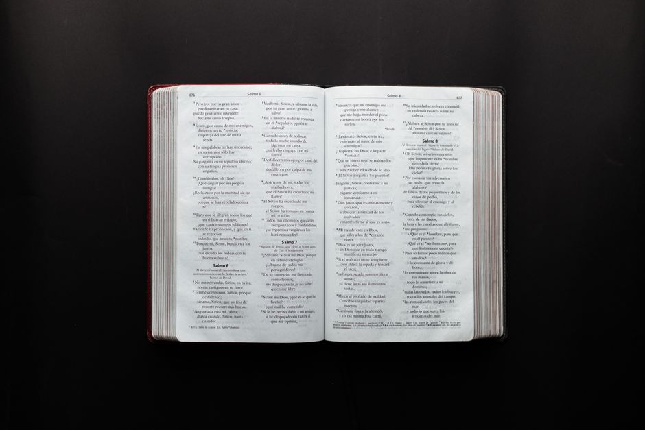 Bible open to Revelation chapter 12 for verse-by-verse commentary and study