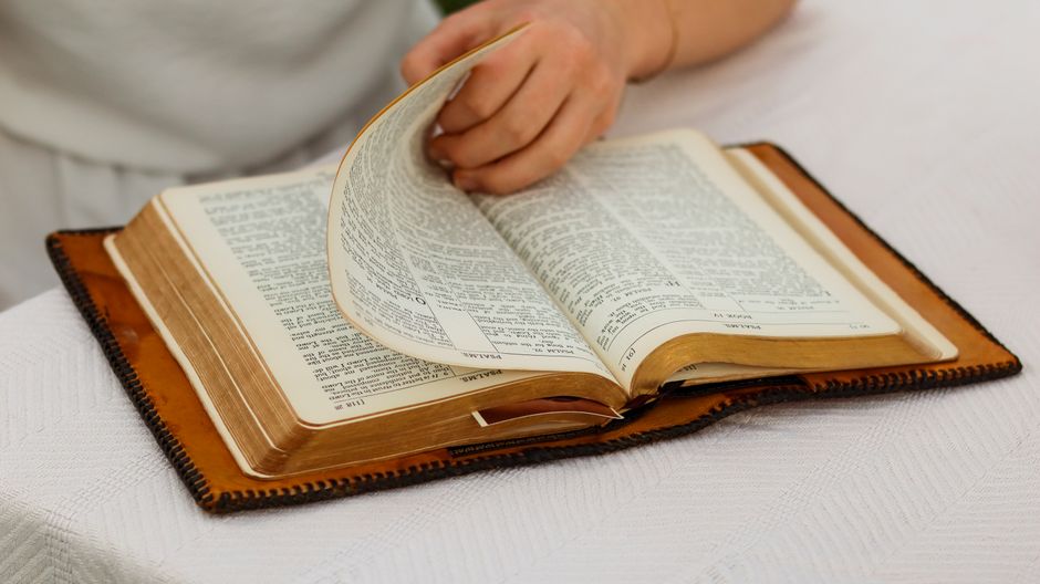 Bible open to Isaiah chapter 54 for verse-by-verse commentary and study