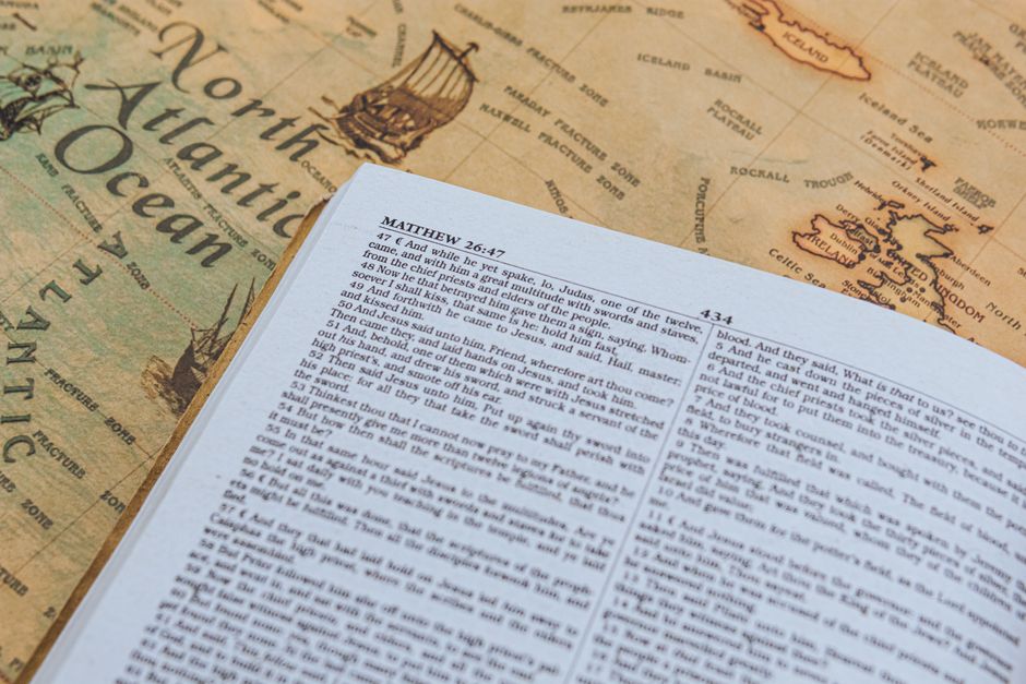 Bible open to Matthew chapter 4 for verse-by-verse commentary and study