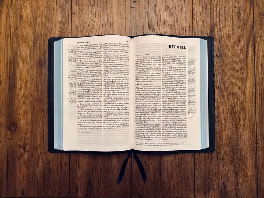 Bible open to John chapter 11 for verse-by-verse commentary and study