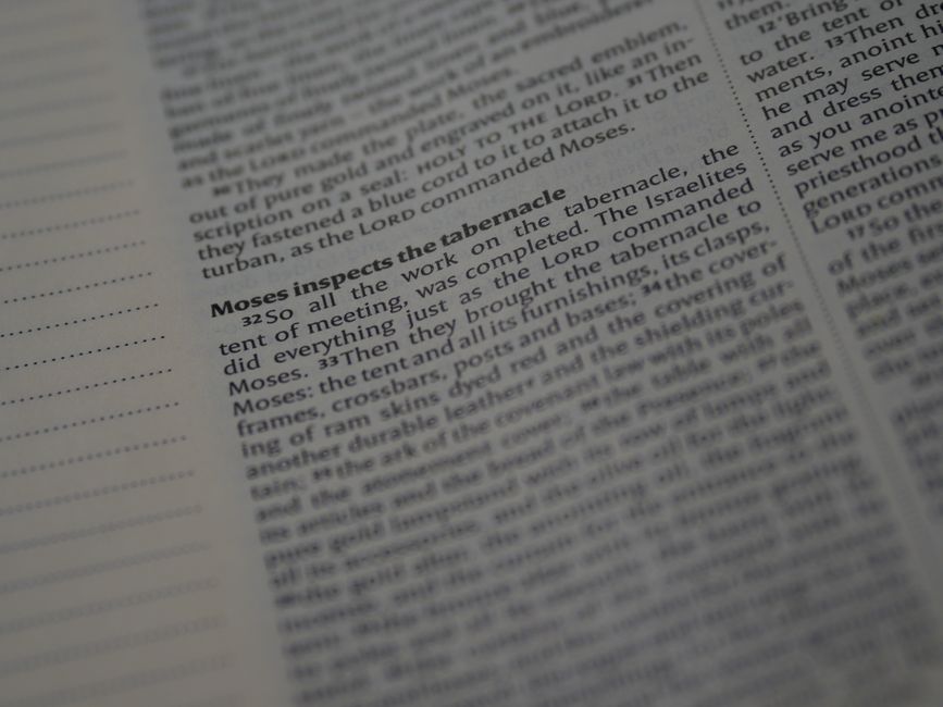 Bible open to Romans chapter 7 for verse-by-verse commentary and study