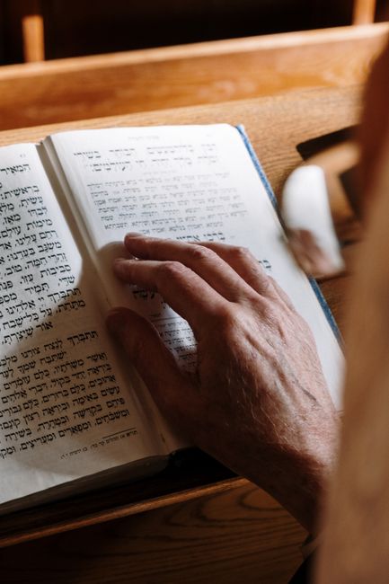 Bible open to 1 John chapter 3 for verse-by-verse commentary and study