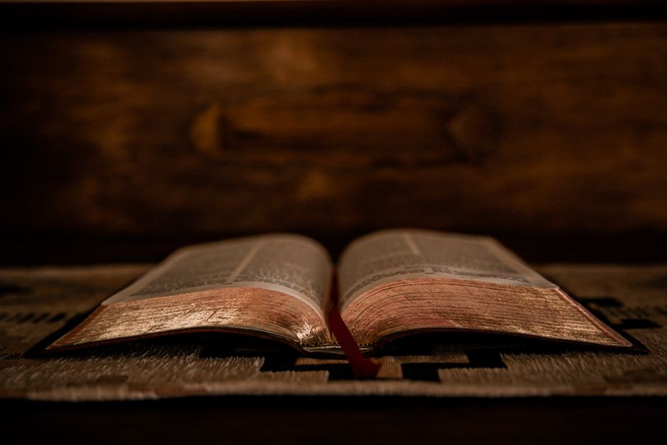 Bible open to Romans chapter 1 for verse-by-verse commentary and study