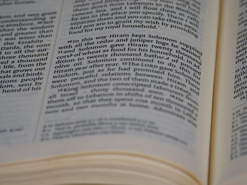 Bible open to Proverbs chapter 25 for verse-by-verse commentary and study