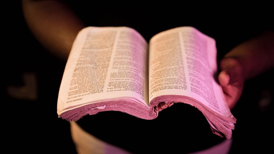 Bible open to Romans chapter 10 for verse-by-verse commentary and study