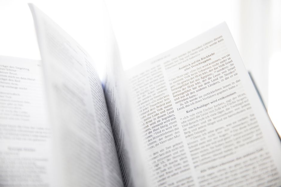 Bible open to Acts chapter 8 for verse-by-verse commentary and study
